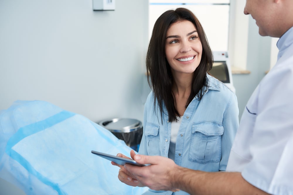 Patient discussing cosmetic surgery consultation questions with a plastic surgeon